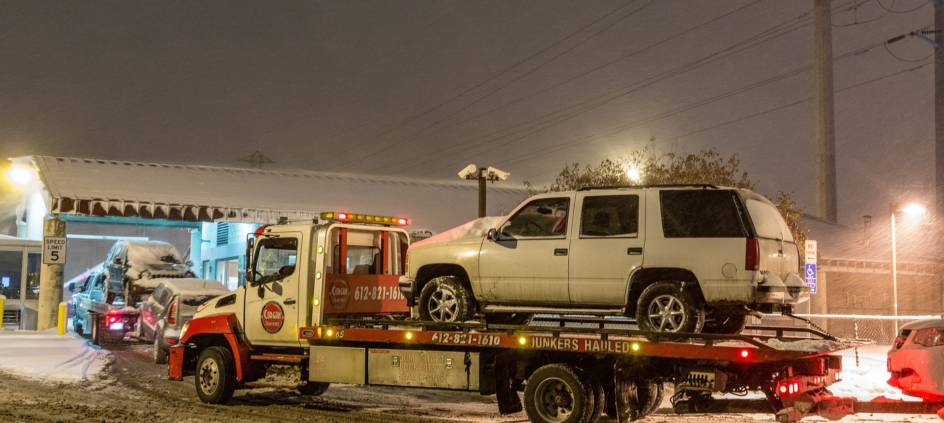 Flatbed tow truck loading a car